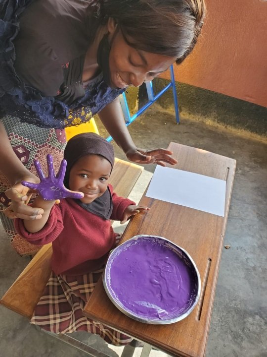 A young child with a painted hand